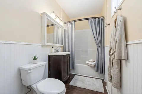 a white toilet sitting next to a bathroom sink