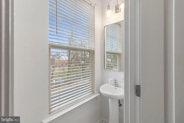 a bathroom with a sink mirror and shower