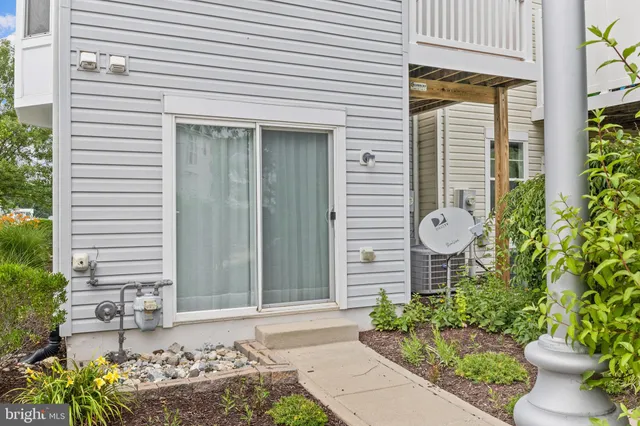 a front view of a house with a yard and potted plants