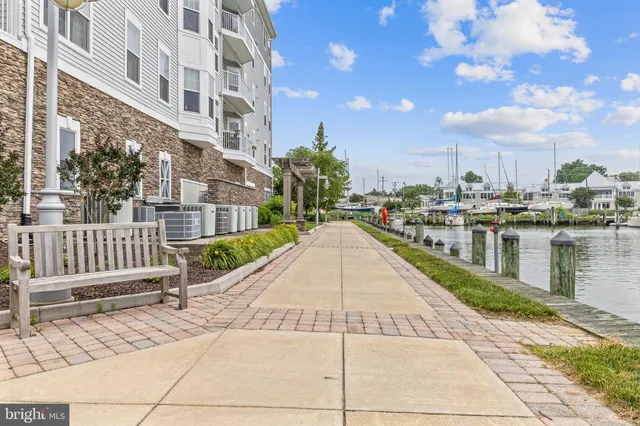 an aerial view of a city with lots of residential buildings ocean and mountain view in back