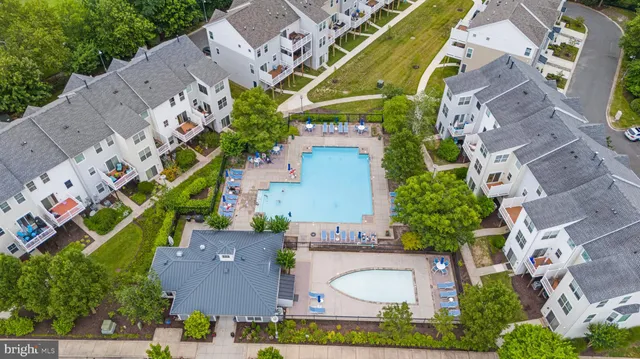 a view of a swimming pool with lawn chairs under an umbrella