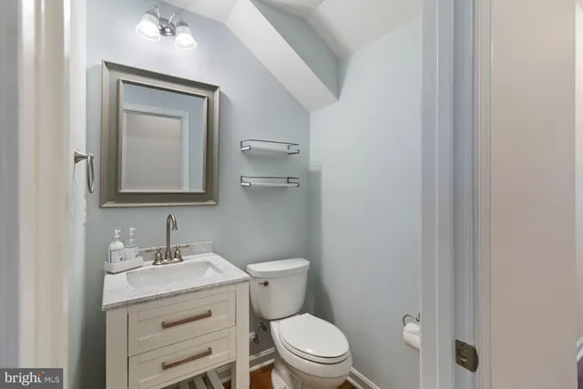 a view of an empty room with a chandelier fan