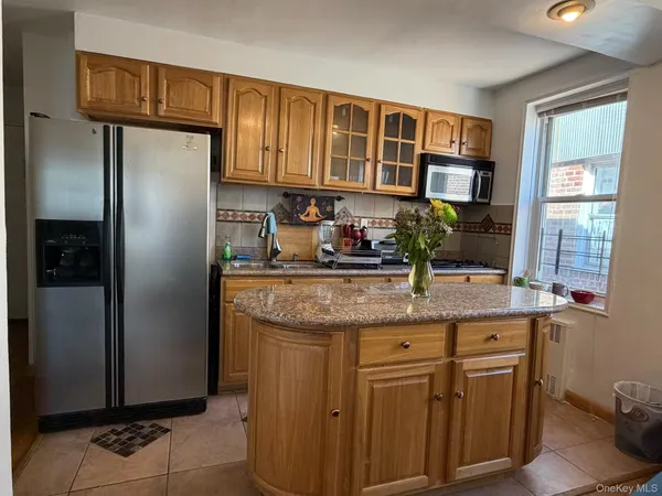 a kitchen with stainless steel appliances granite countertop a refrigerator and a sink