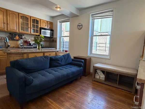 a living room with furniture a fireplace and a window