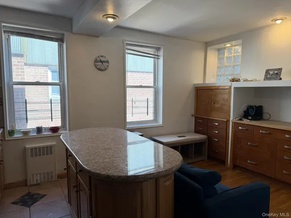 a kitchen with a sink a window and chairs