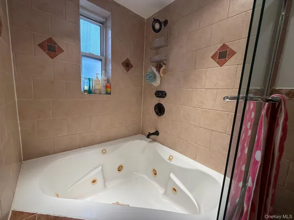 a bathroom with a tub and shower
