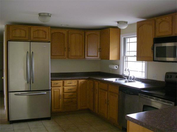 105 Slab Bridge Road Freetown, MA 02702 - Photo 2 of 6 a kitchen with stainless steel appliances granite countertop a refrigerator a sink dishwasher a stove and a microwave oven on granite countertops