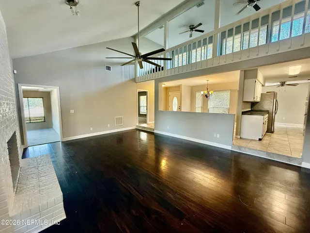 a view of a living room with hardwood floor