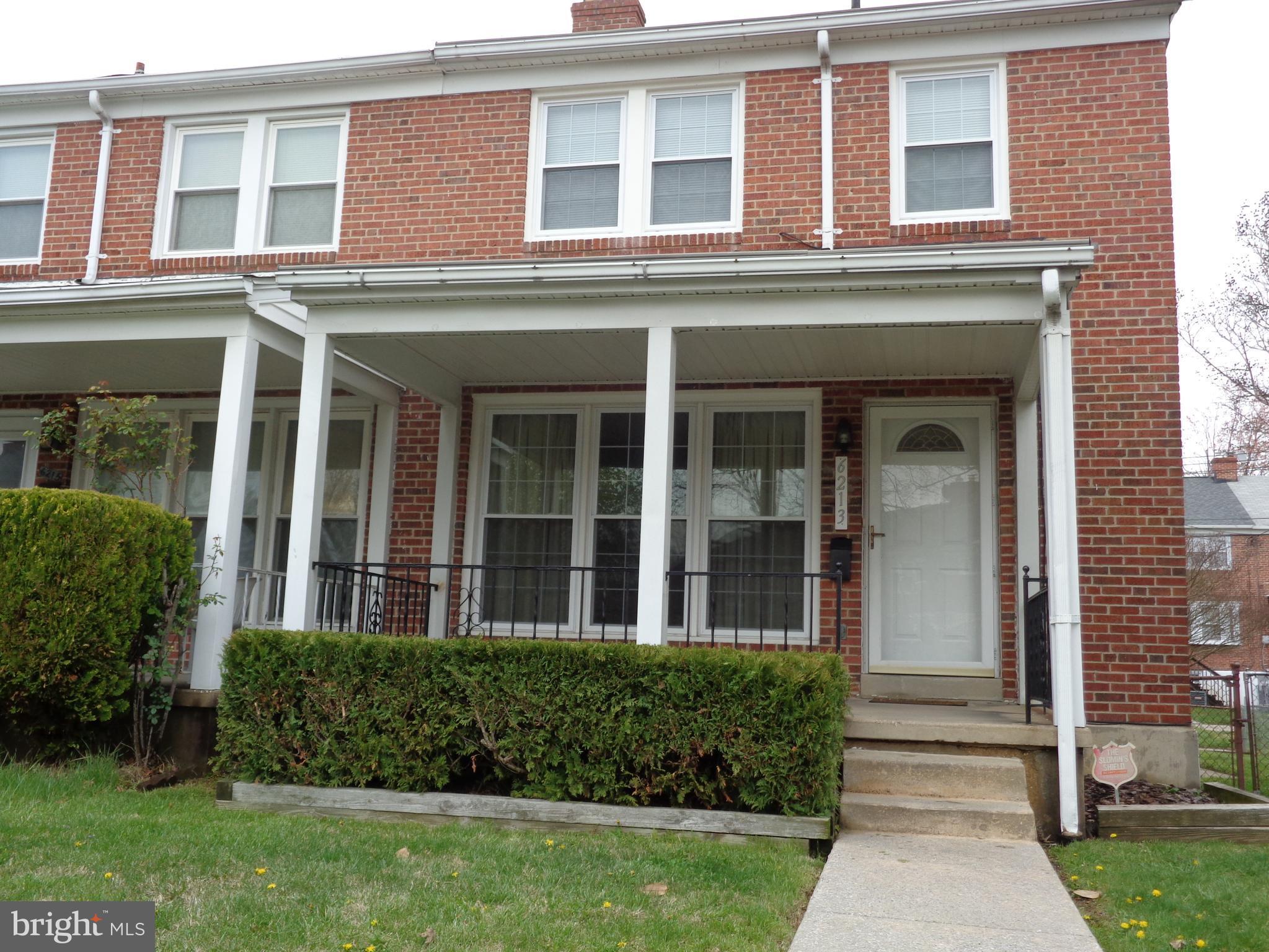 6213 Marlora Road Baltimore, MD 21239 - Photo 1 of 26 front view of a brick house with a yard