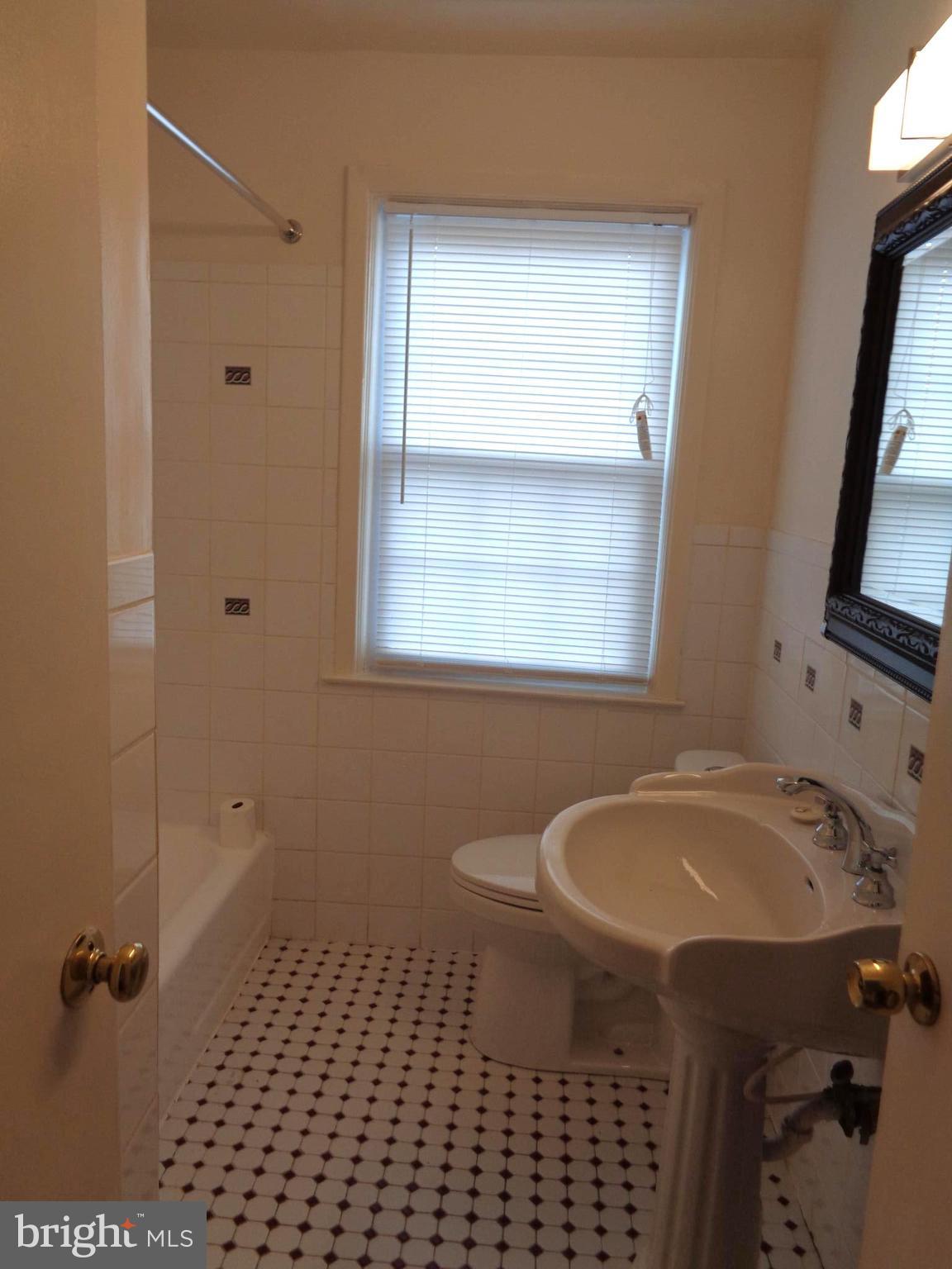 6213 Marlora Road Baltimore, MD 21239 - Photo 12 of 26 a bathroom with a sink a toilet and a mirror