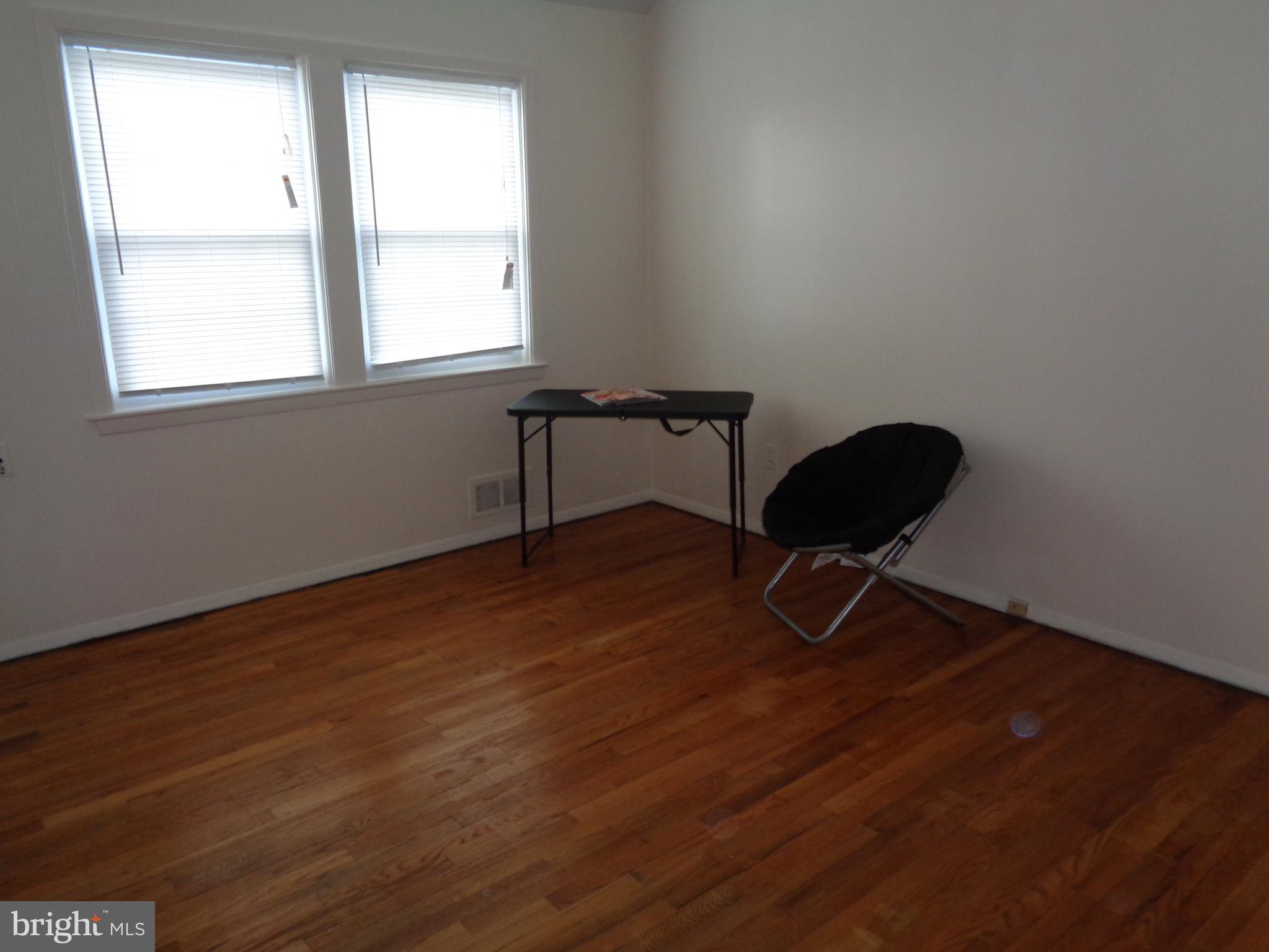 6213 Marlora Road Baltimore, MD 21239 - Photo 13 of 26 a view of a workspace with wooden floor and a window