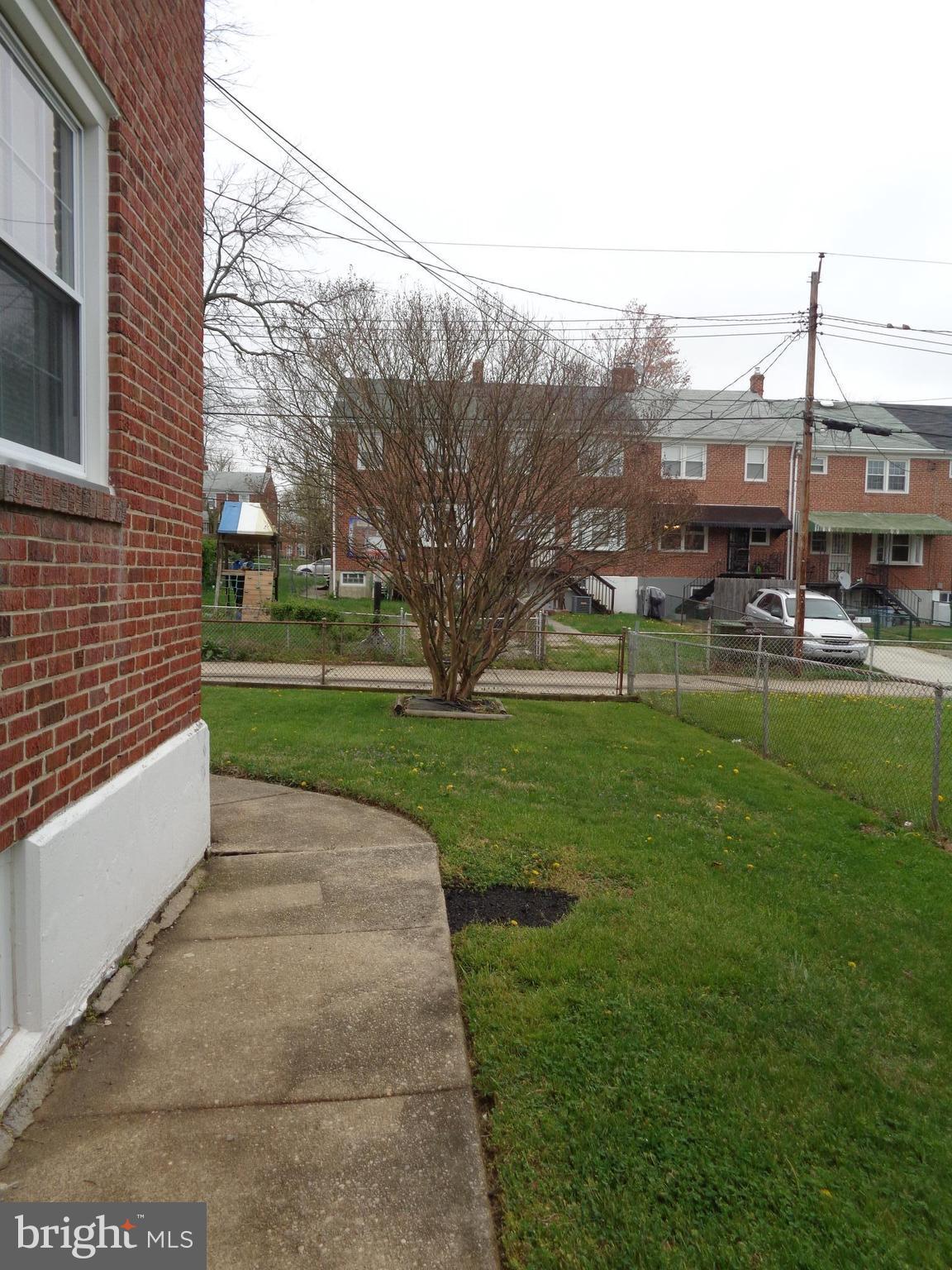 6213 Marlora Road Baltimore, MD 21239 - Photo 22 of 26 a view of a patio with table and chairs with wooden fence