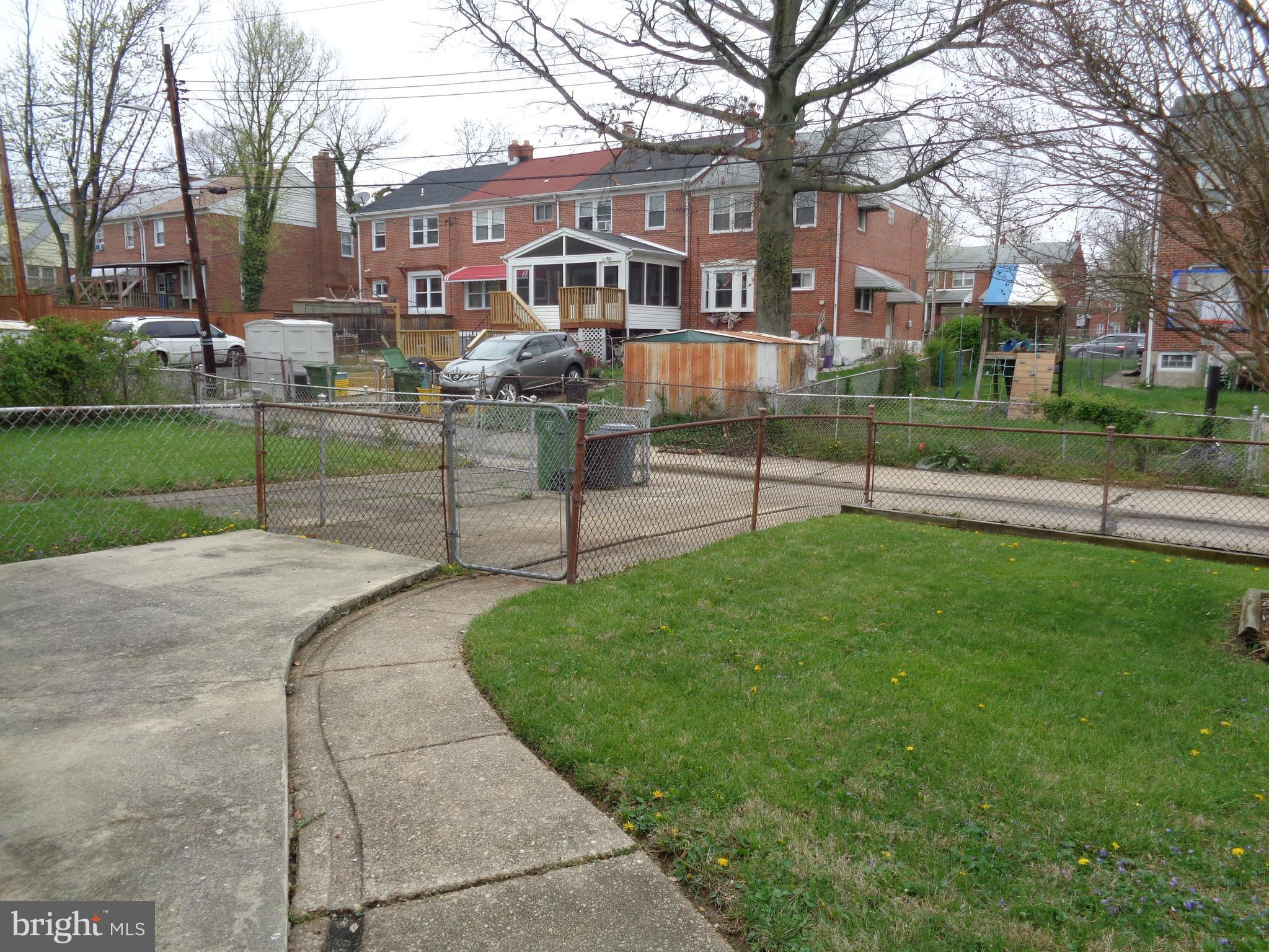 6213 Marlora Road Baltimore, MD 21239 - Photo 23 of 26 a view of a house with a yard