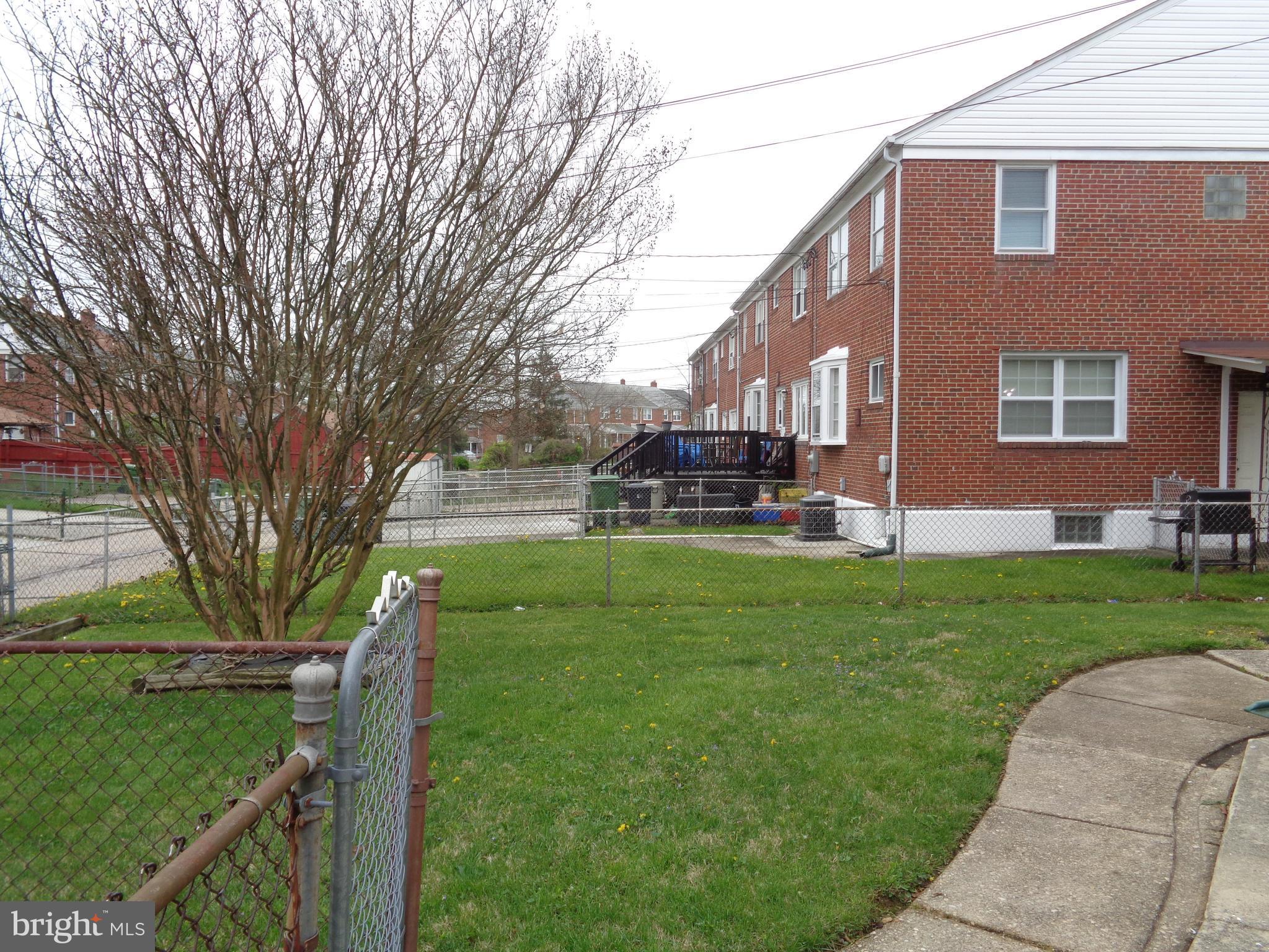 6213 Marlora Road Baltimore, MD 21239 - Photo 24 of 26 a view of a house with a yard
