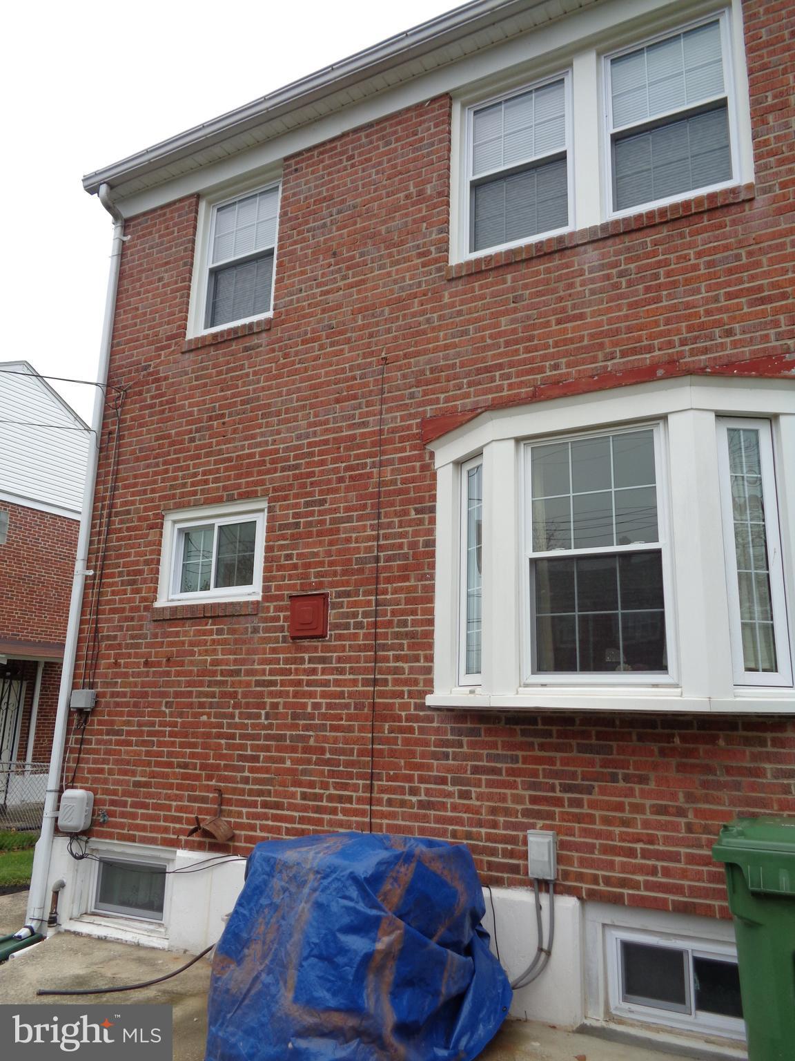 6213 Marlora Road Baltimore, MD 21239 - Photo 25 of 26 a brick house with four windows