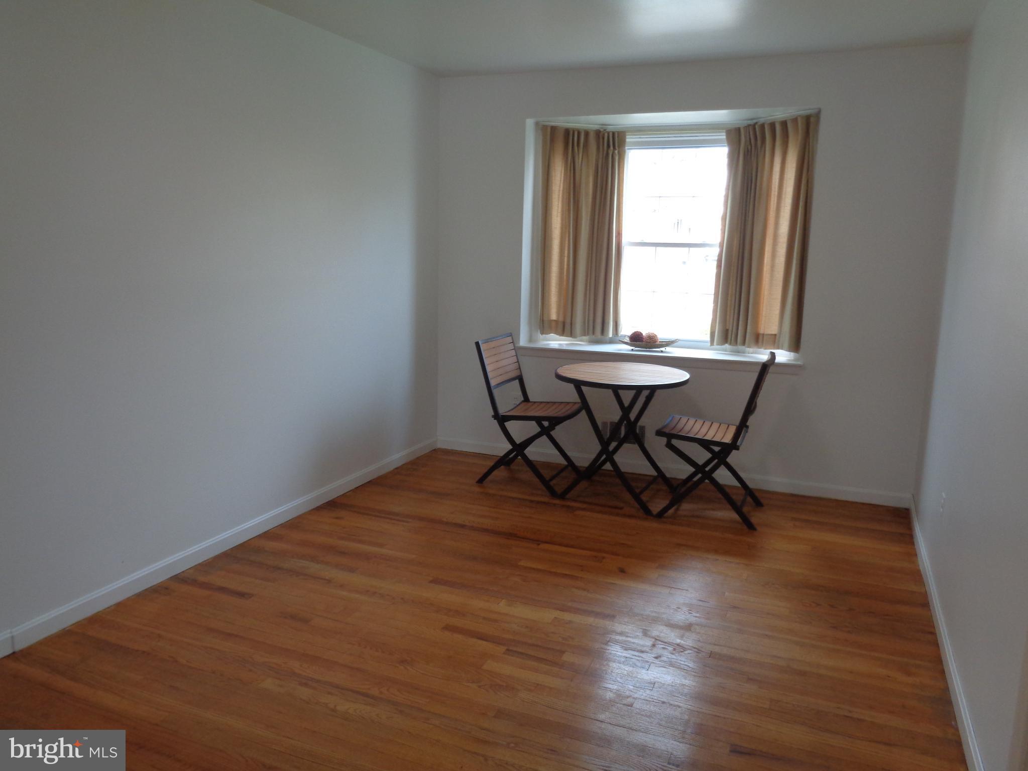 6213 Marlora Road Baltimore, MD 21239 - Photo 4 of 26 a room with wooden floor and a window