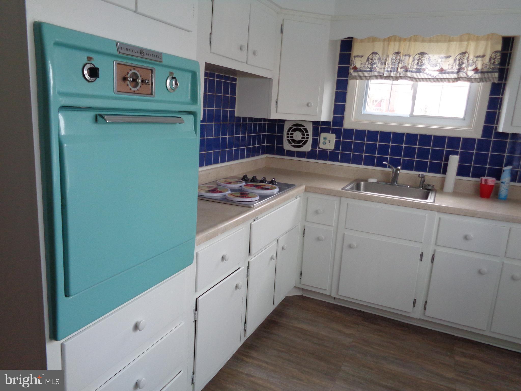 6213 Marlora Road Baltimore, MD 21239 - Photo 8 of 26 a kitchen with white cabinets and sink