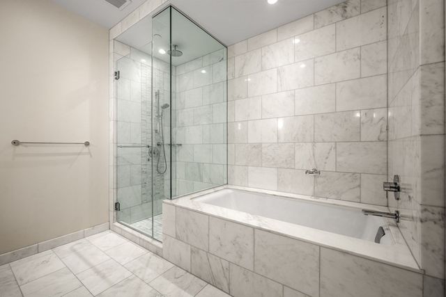 a spacious bathroom with a bathtub and a shower