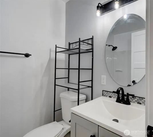 a bathroom with a sink toilet and mirror