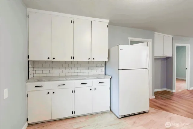 a white refrigerator freezer sitting in a kitchen