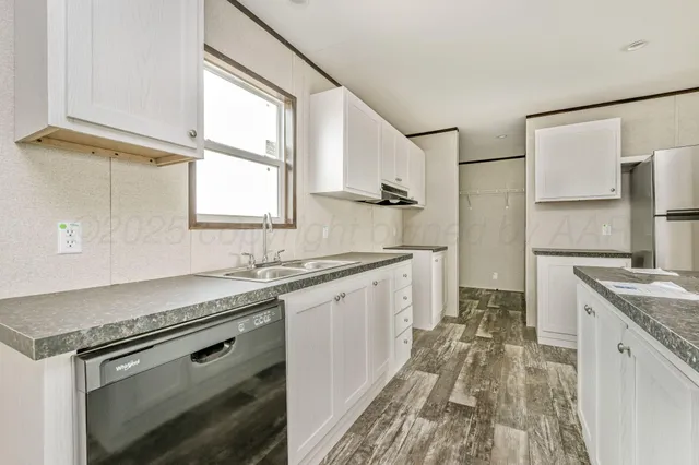 a kitchen with granite countertop a stove and a refrigerator