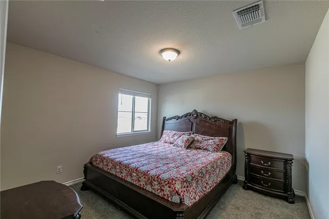 a bedroom with a bed and a tv