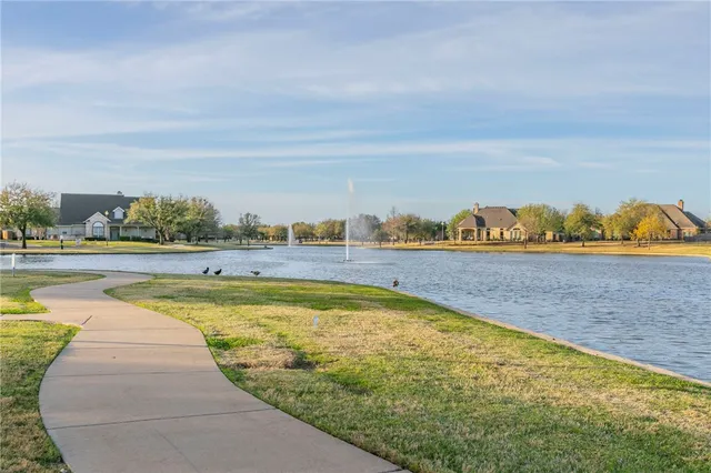 a view of swimming pool with outdoor seating and yard in back