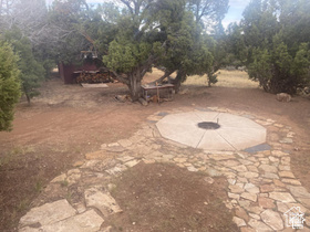 45711 Colt Road, Unit 131 Fruitland, UT 84027 - Photo 19 of 37 Stone pathway leading to a circular fire pit