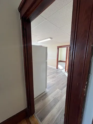 a view of hallway with wooden floor