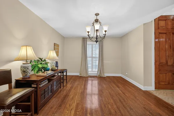 a view of a room with wooden floor windows and a chandelier