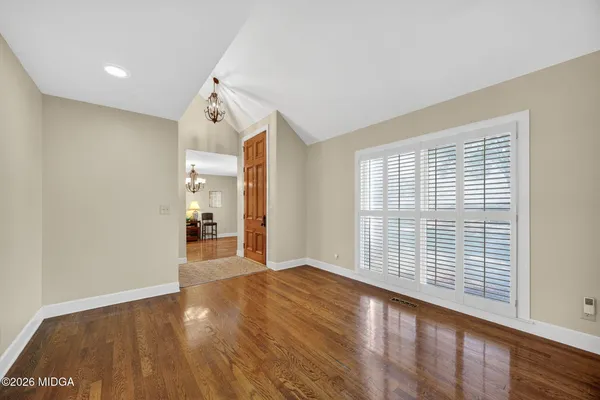wooden floor in an empty room with a window