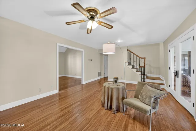 a living room with furniture and a wooden floor