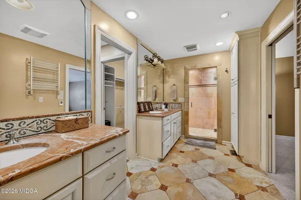 a bathroom with a granite countertop sink mirror and shower