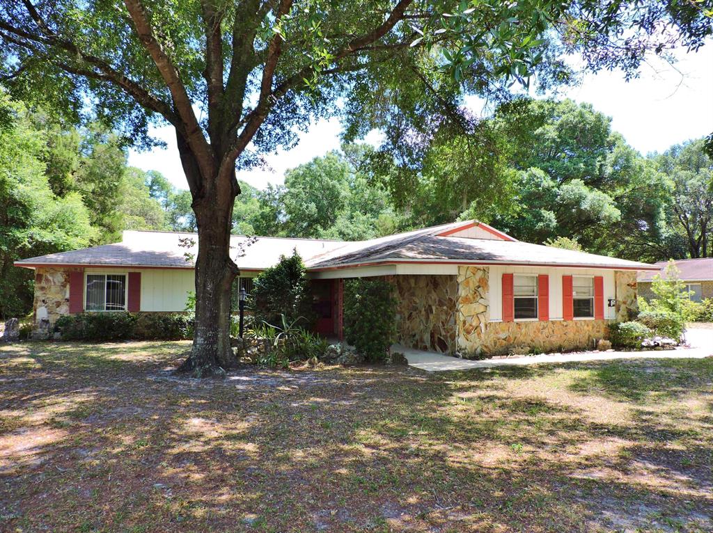 10139 Southwest 81st Terrace Road Ocala, FL 34481 - Photo 1 of 1 a house with trees in the background