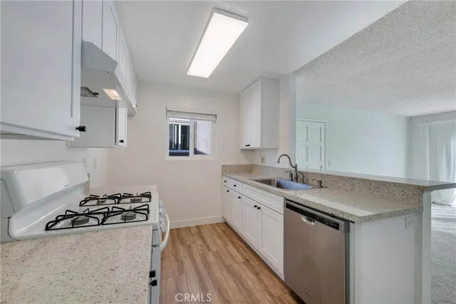 a kitchen with a sink stove and cabinets