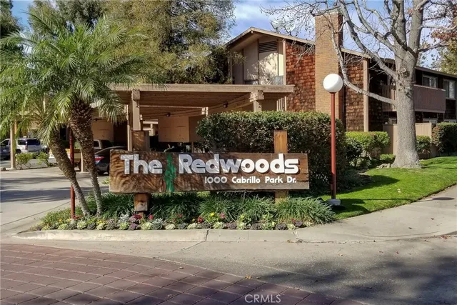 a backyard of a house with lots of green space and garden