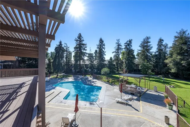 a view of a chair and table in the back yard of the house