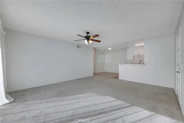 a view of a utility room with a ceiling fan