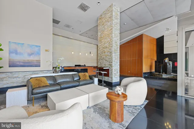 a living room with patio furniture and a dining table