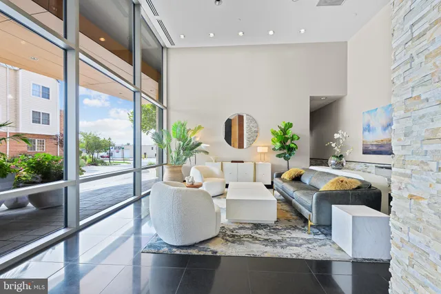 a living room with fireplace furniture and a floor to ceiling window