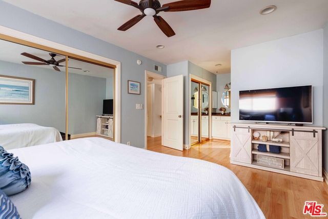 a bedroom with a flat screen television and a bed