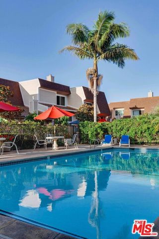 a view of a house with pool and a yard