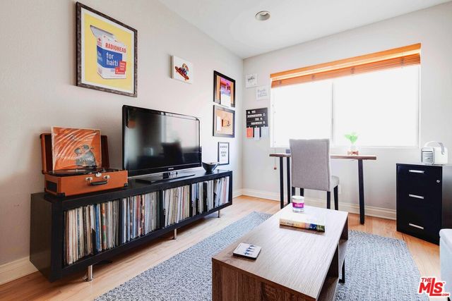 a living room with furniture rug and wooden floor