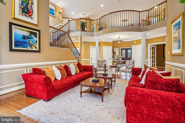 a view of a hallway with wooden floor and windows