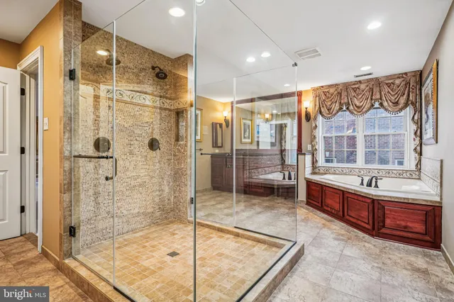 a en suite bathroom with a sink double vanity and a mirror