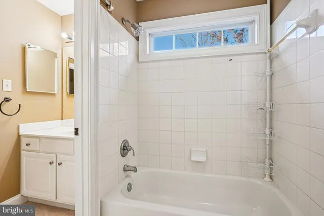 a kitchen with stainless steel appliances kitchen island granite countertop a sink a stove a dining table and chairs