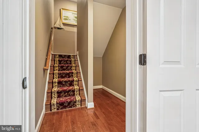 a bed sitting in a bedroom next to a cabinet