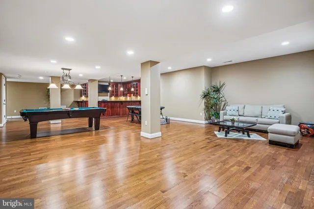 a view of a room with wooden floor and lounge chair
