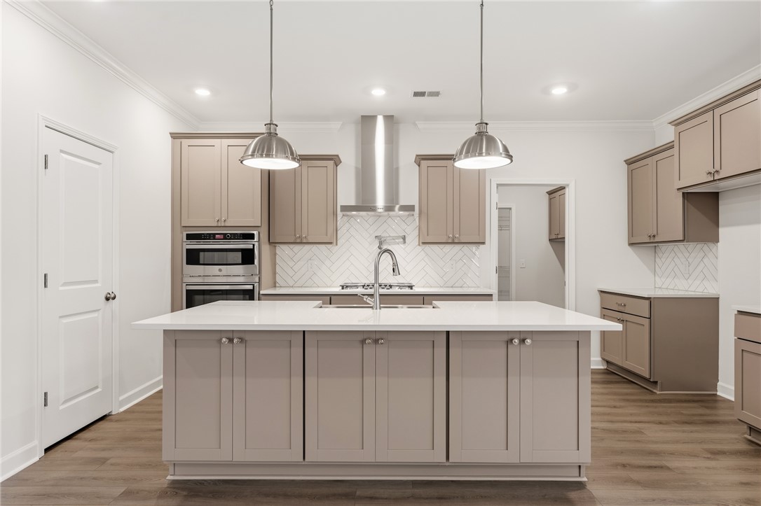110 Lakeside Drive Anderson, SC 29621 - Photo 14 of 34 This kitchen features a central island, modern appliances, and stylish cabinetry, ideal for culinary endeavors.