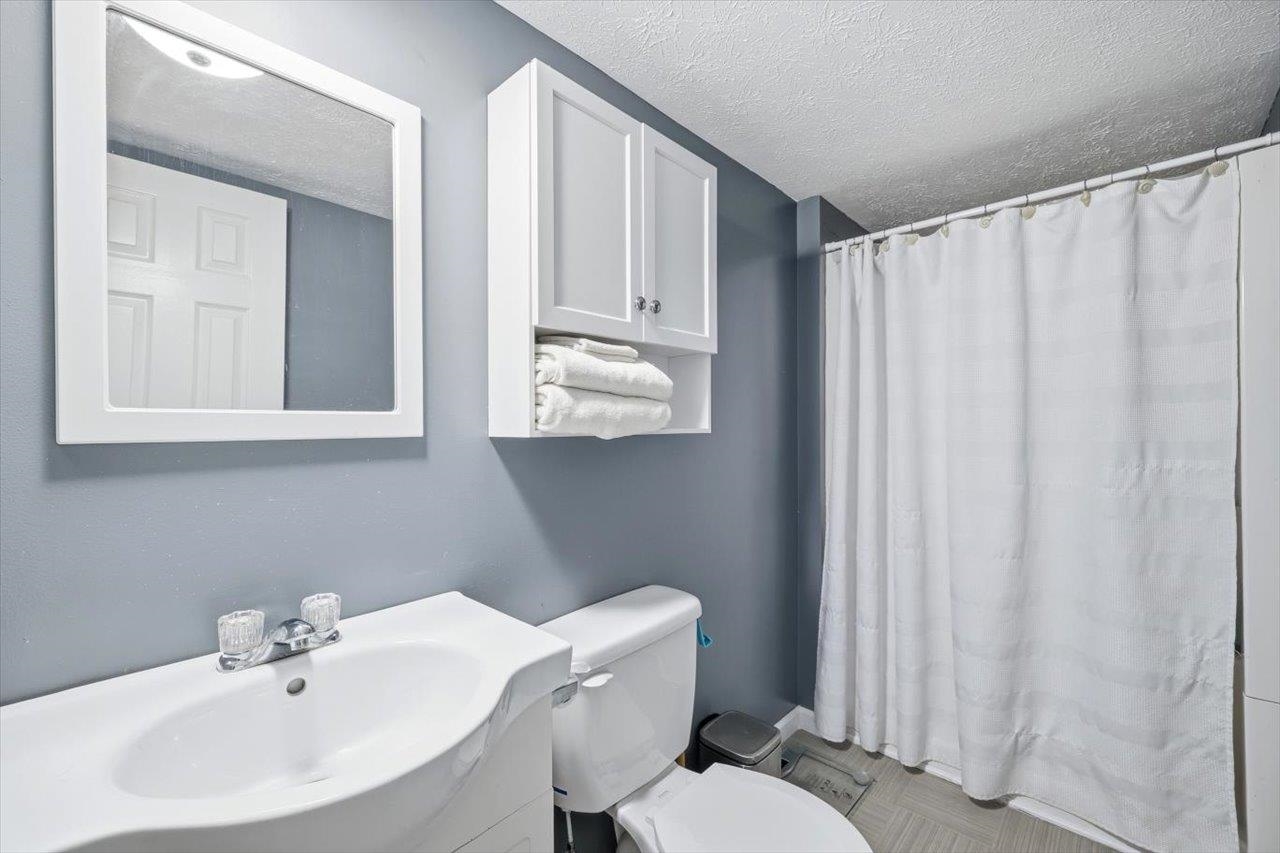 406 Trayfoot Road Grottoes, VA 24441 - Photo 15 of 30 a bathroom with a sink a toilet and mirror